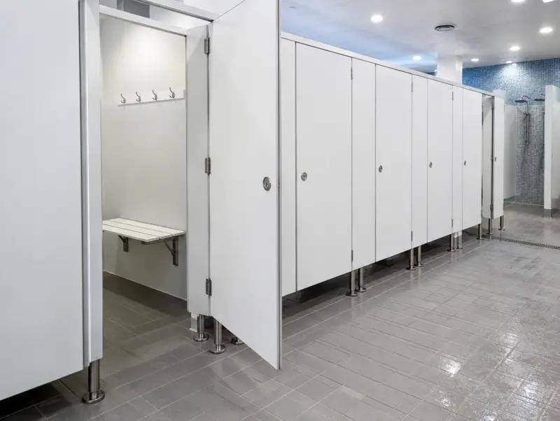 White compact laminate shower and changing cubicles in a leisure centre changing village